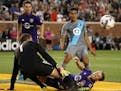Minnesota United midfielder Johan Venegas (11) watched as Orlando City SC defender Jonathan Spector (2) dove in to clear a cross in front of Orlando C