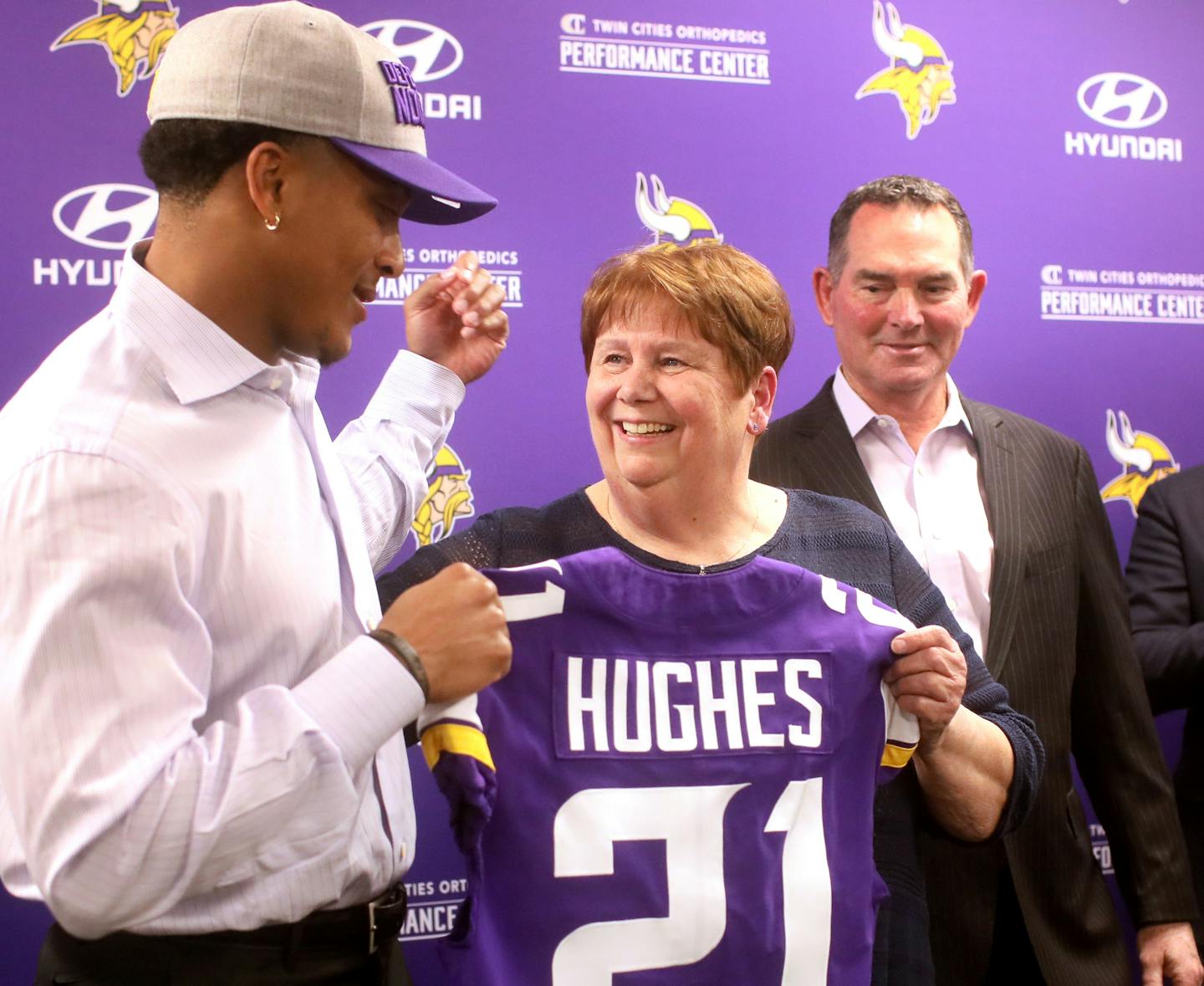 Minnesota Vikings first round pick cornerback Mike Hughes from the University of Central Florida, posed for a photo with Penny Bryce, Vikings head seamstress for the past 49 years, who has sewed the names of Vikings players on jerseys during that time and Hughes first round draft that she will sew as she retires this year. Looking on is Vikings head coach Mike Zimmer Friday, April 27, 2018, at the Twin Cities Orthopedics Media Center.] DAVID JOLES &#xef; david.joles@startribune.com Vikings CB Mi