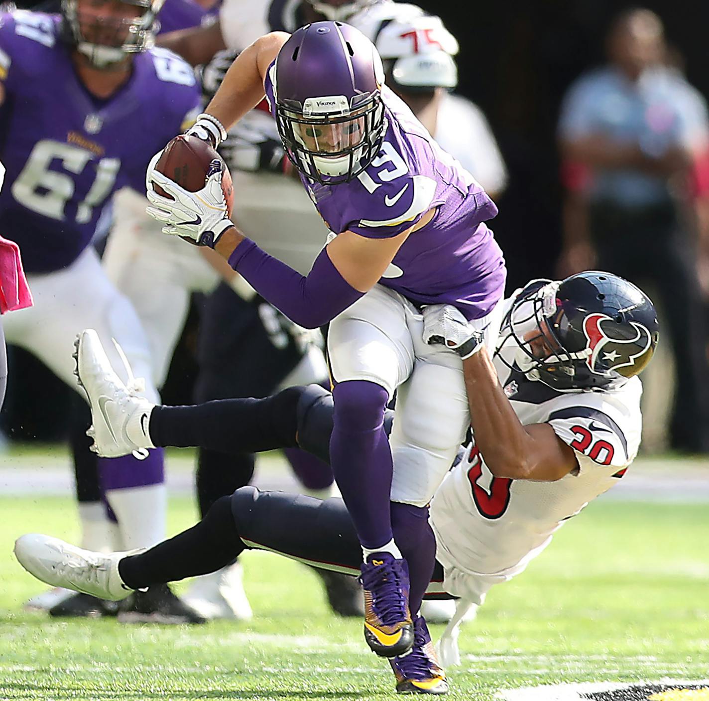 Minnesota Vikings wide receiver Adam Thielen carried the ball despite being held by Houston Texans cornerback Kevin Johnson during the third quarter as the Vikingstook on the Houston Texans at US Bank Stadium, Sunday, October 9, 2016 in Minneapolis, MN. ] (ELIZABETH FLORES/STAR TRIBUNE) ELIZABETH FLORES &#x2022; eflores@startribune.com