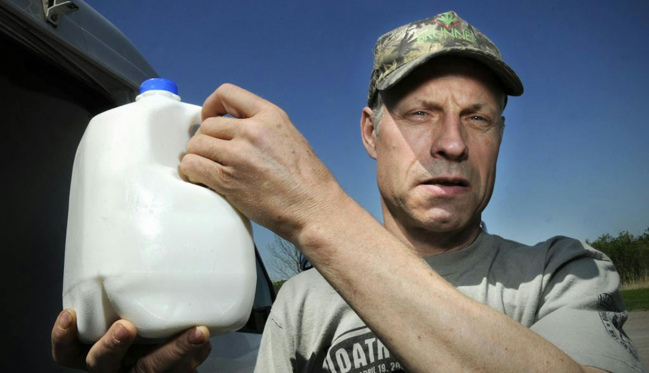 May 2012: Alvin Schlangen holds a gallon of raw milk.