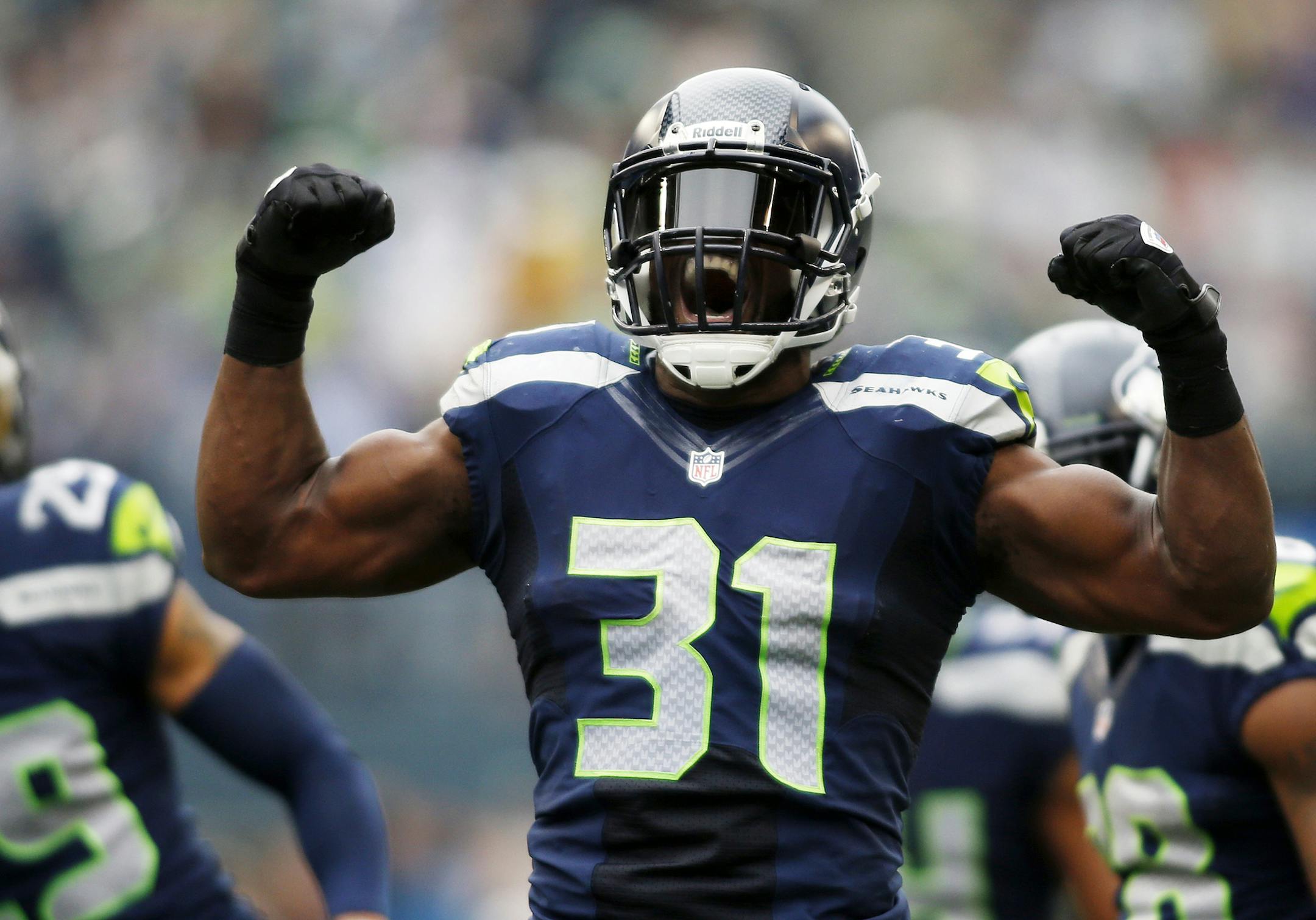 Seattle Seahawks strong safety Kam Chancellor (31) celebrates a hit on St. Louis Rams' Stedman Bailey in the first half of an NFL football game, Sunday, Dec. 29, 2013, in Seattle. (AP Photo/John Froschauer) ORG XMIT: SEA119