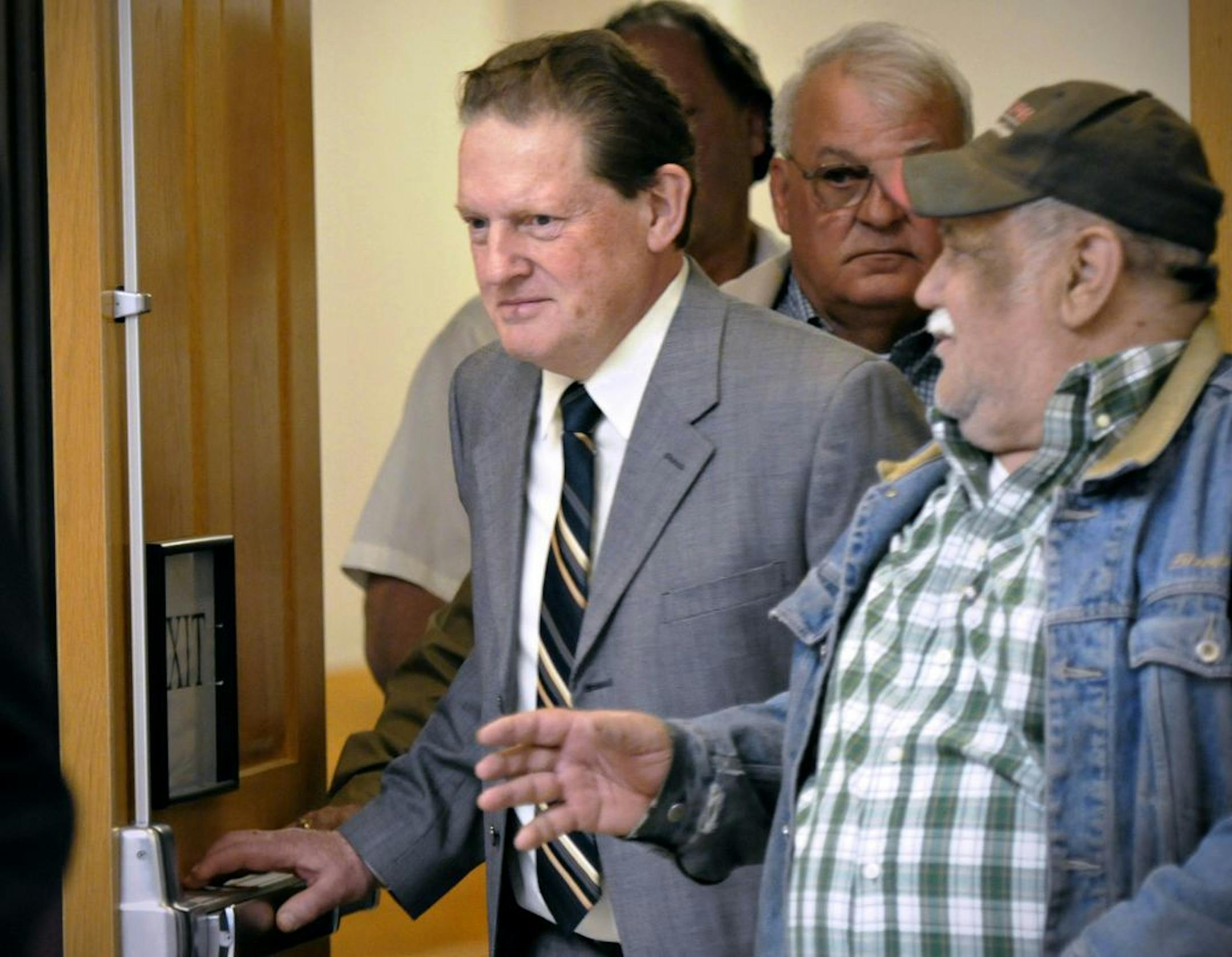 Byron Smith, center, comes out of a Morrison County courtroom in Little Falls, Minn., during a break in his trial.