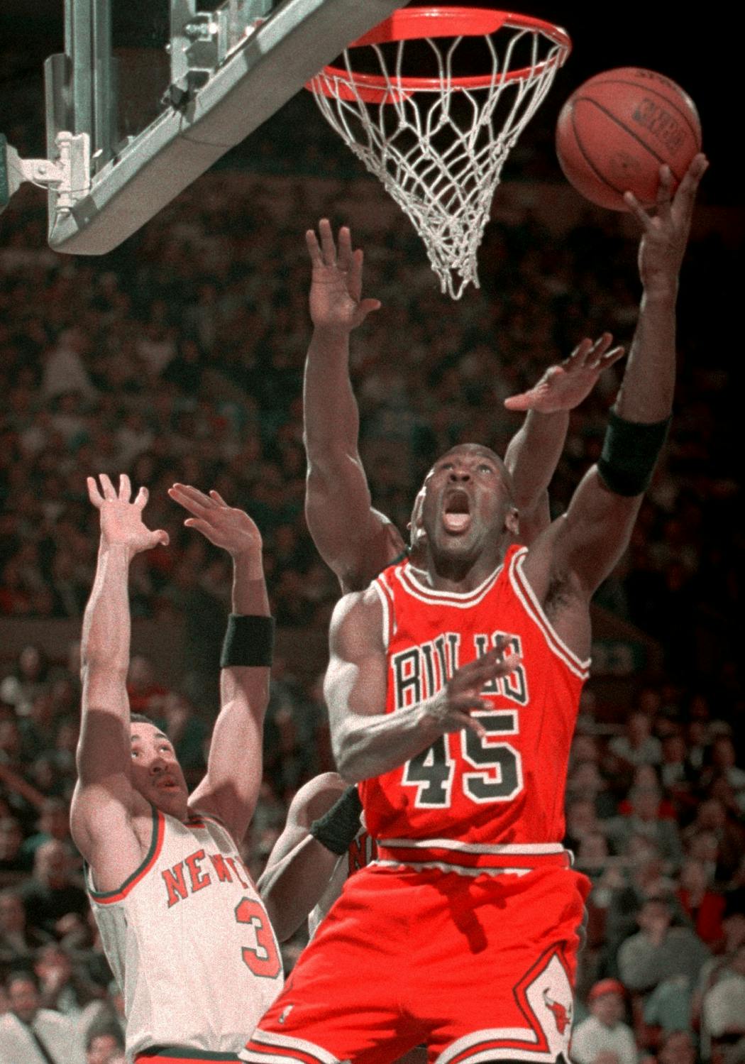 Michael Jordan goes to the hoop over New York Knicks guard John Starks at New York's Madison Square Garden