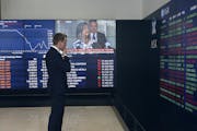 A man stands in the viewing gallery at the Australian Stock Exchange in Sydney, Monday, March 9, 2020. Asian stock market plunge after fall in oil pri