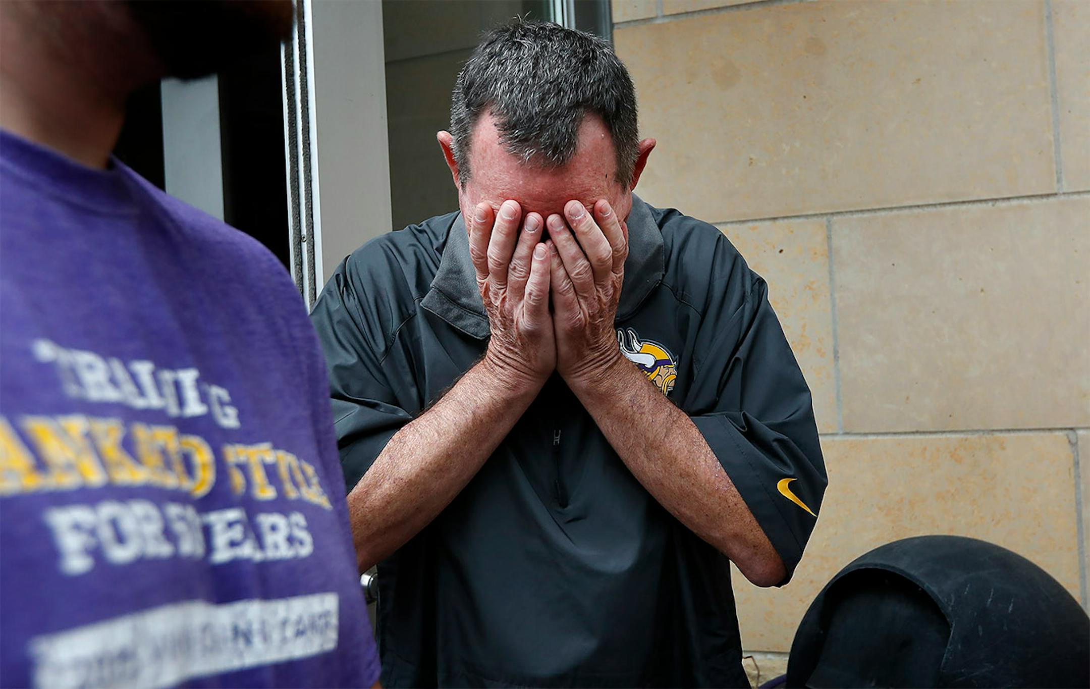 Minnesota Vikings head coach Mike Zimmer reacted as general manager Rick Spielman spoke to the media about Zimmer's contract extension.