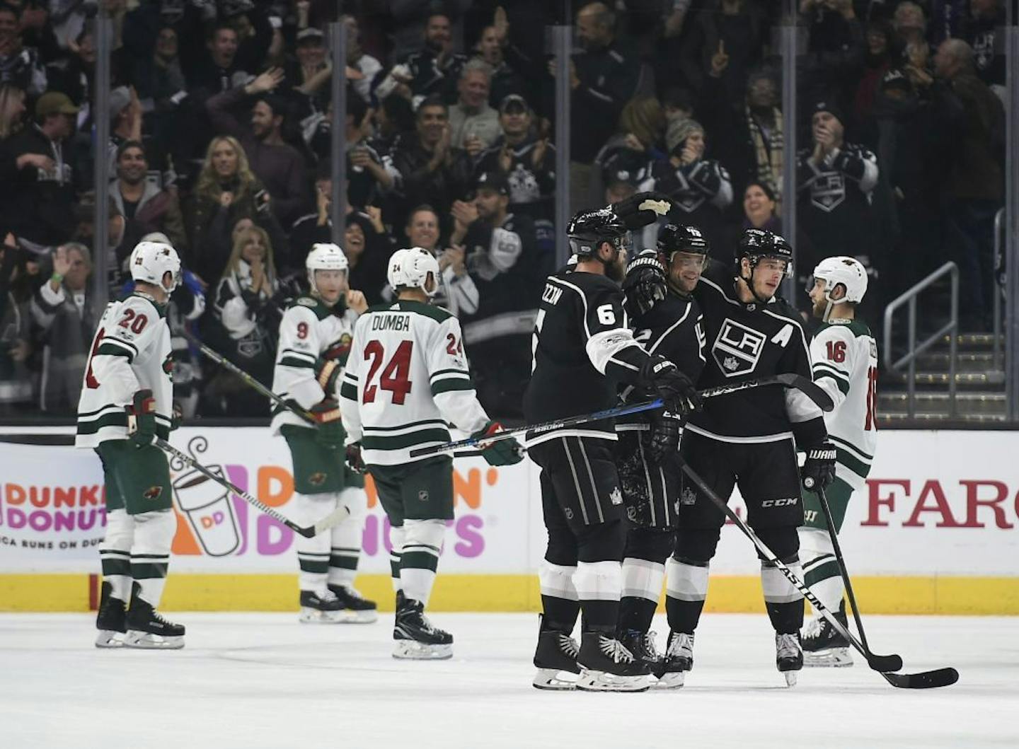 Los Angeles Kings right wing Marian Gaborik, center, celebrates his goal with right wing Dustin Brown, right, and defenseman Jake Muzzin during the third period of an NHL hockey game against the Minnesota Wild in Los Angeles, Tuesday, Dec. 5, 2017. The Kings won 5-2.