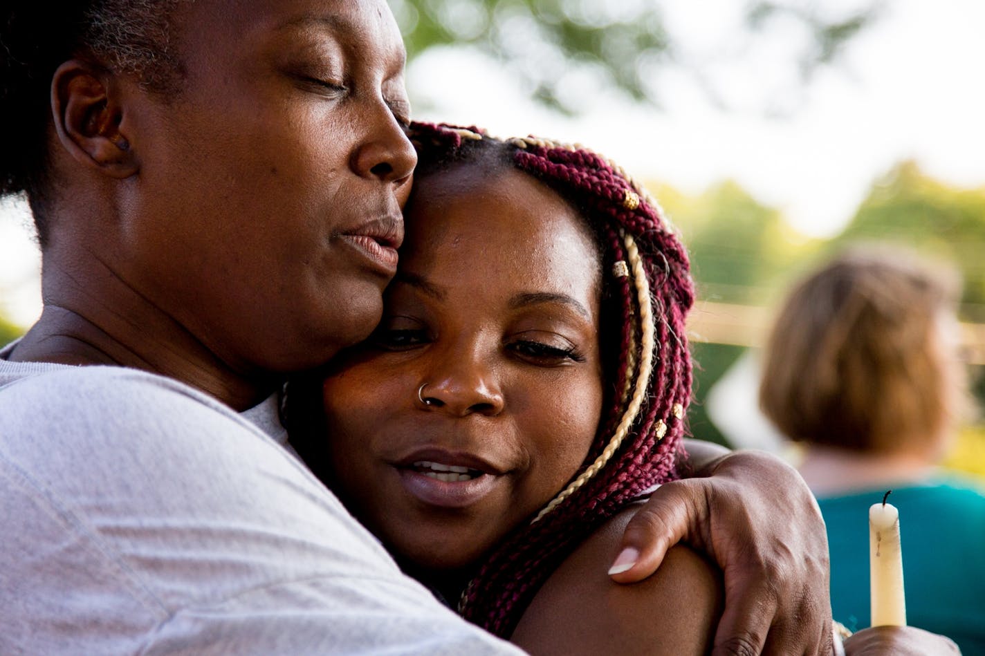 Kenyatta Foster (right) hugs Missy Sims, her father�s childhood friend, during a vigil for Kenneth J. Foster who was killed when a car drove into a bus.