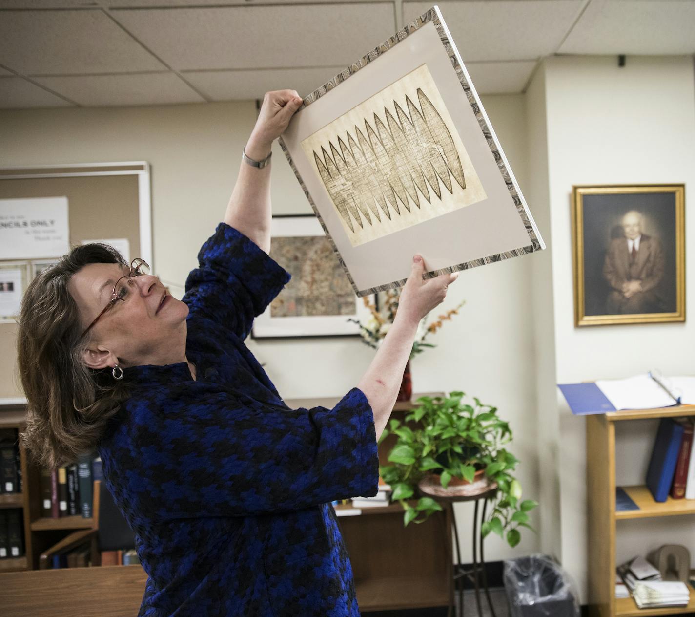 Marguerite Ragnow, curator of the James Ford Bell Library, held the globe gores map up to the light to show some of its distinctive characteristics.