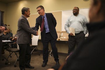 Richfield Mayor Pat Elliott, left, shook hands with Eric Schnell, COO of Aeon, after Elliott told the roomful of people there to attend a city council