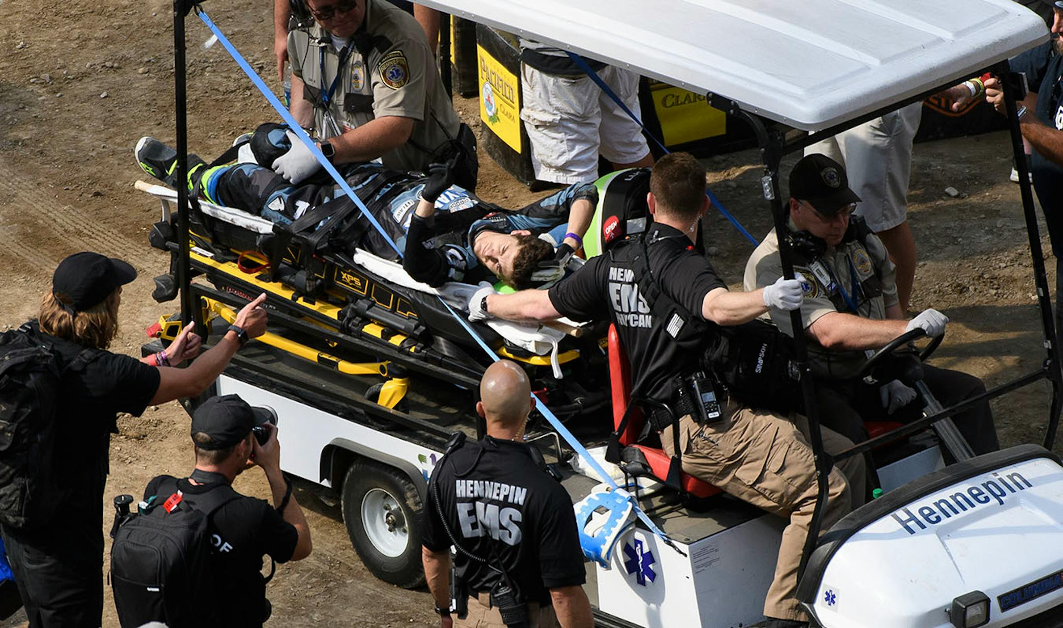 Jarryd McNeil gestured to fans as he was carted off the dirt after a bad fall in the motocross quarter pipe high air final.