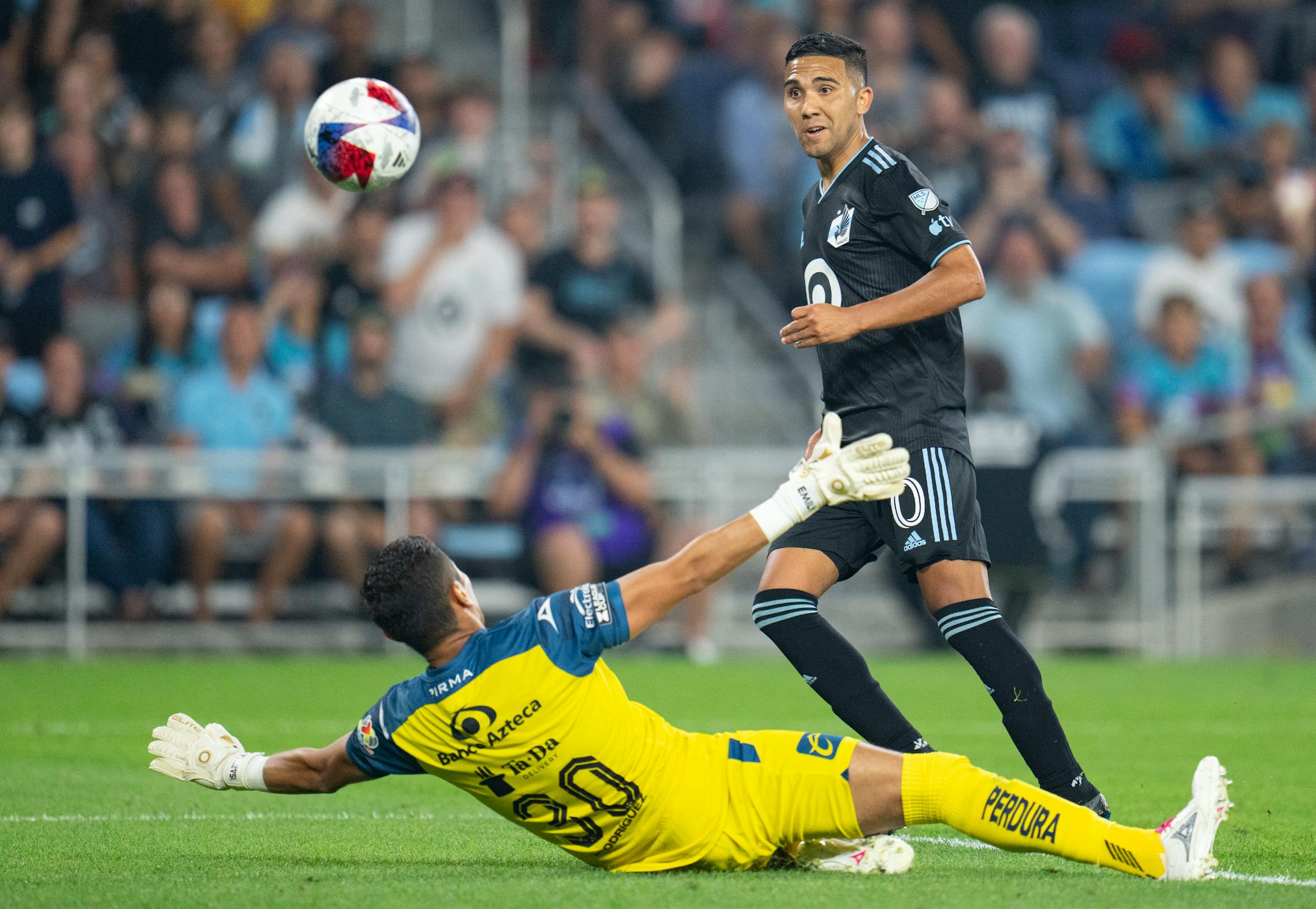 Minnesota United midfielder Emanuel Reynoso scores a goal over Puebla goalkeeper Jesús Rodríguez (30) in the second half of a Leagues Cup match Sunday night.