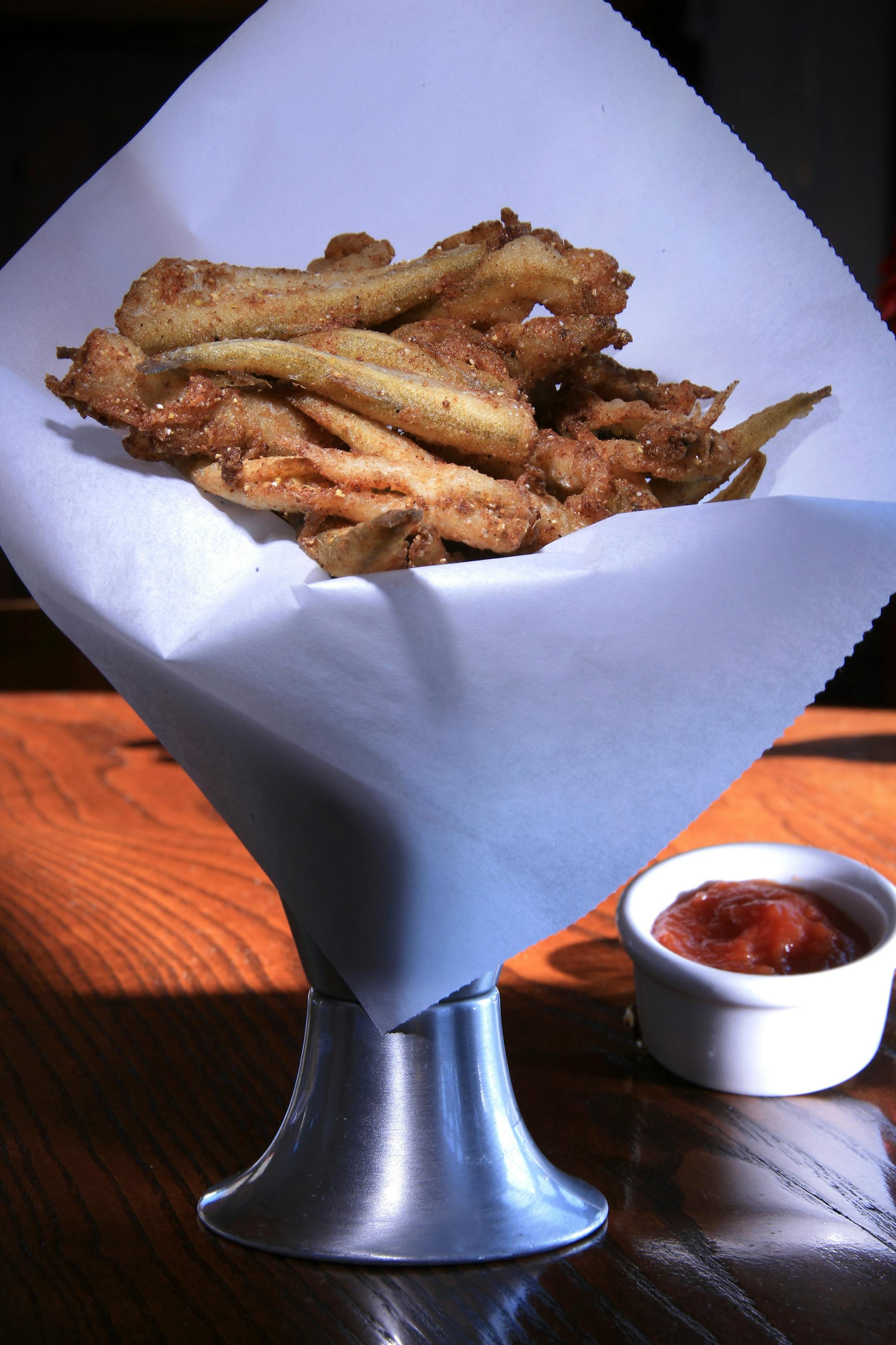 Smelt fries are served with smoked tomoto ketchup and a sweet onion tartar sauce (not shown).