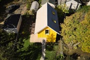 The 715-square-foot freestanding, two-story ADU named Sunflower is screened from the street behind the primary residence. Window placement caters to b
