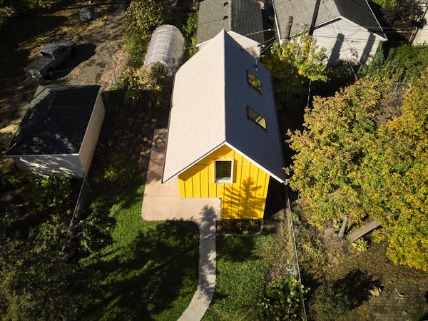 The 715-square-foot freestanding, two-story ADU named Sunflower is screened from the street behind the primary residence. Window placement caters to b