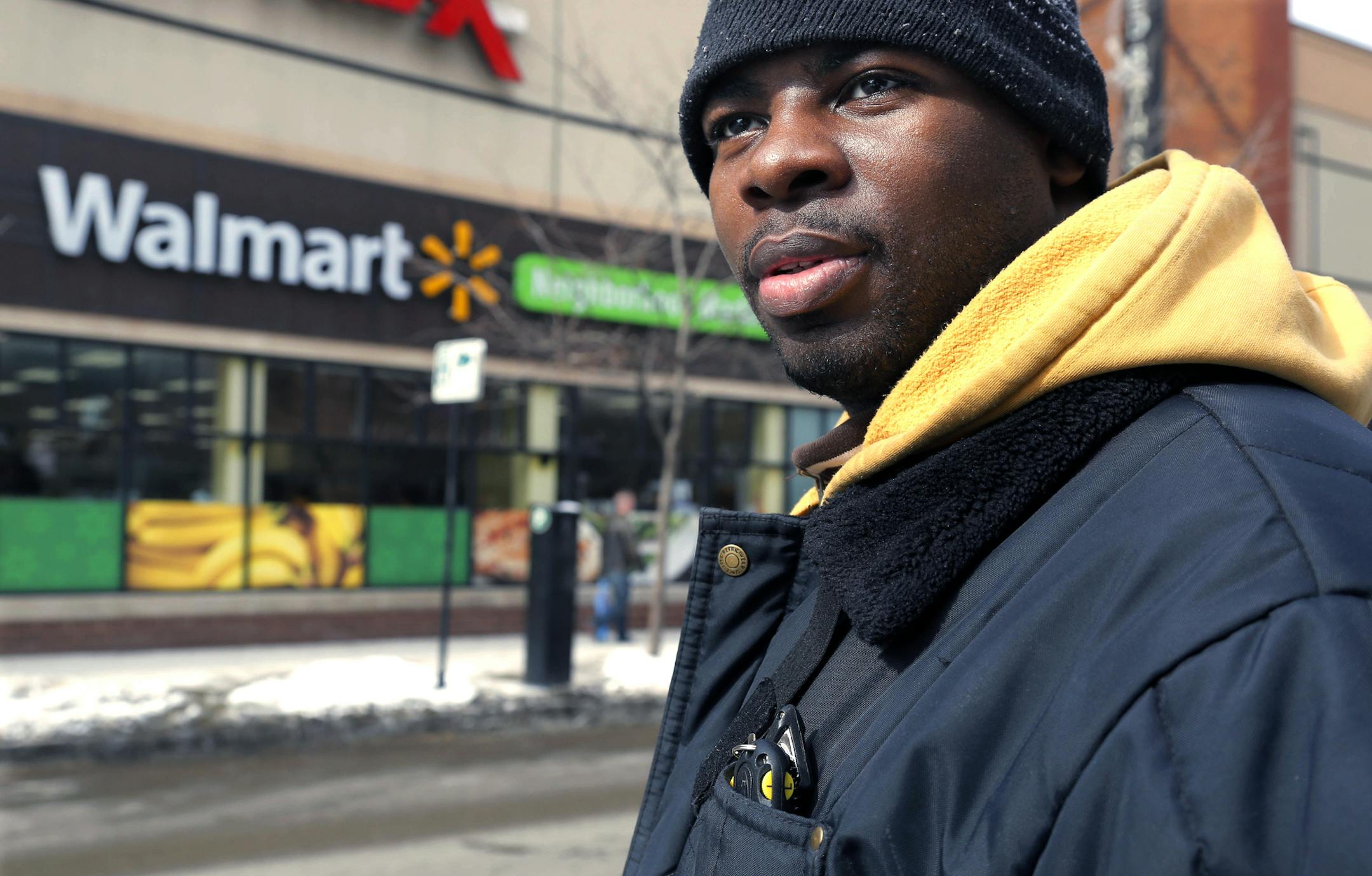 In this Tuesday, March 4, 2014, photo, Wal-Mart employee Richard Wilson, 27, is photographed outside the store where he works in Chicago.