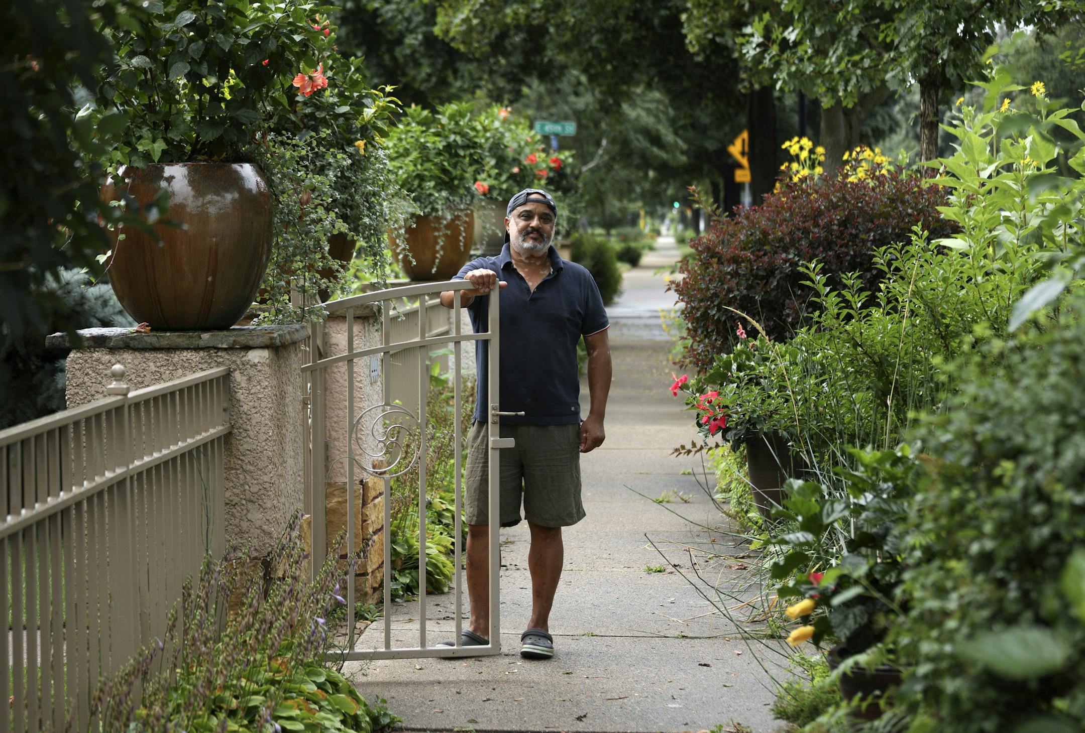 Alex Ghebregzi has created a boulevard garden that extends across two side-by-side homes he owns on Portland Avenue. He calls his boulevard garden "the Hibiscus Walk."