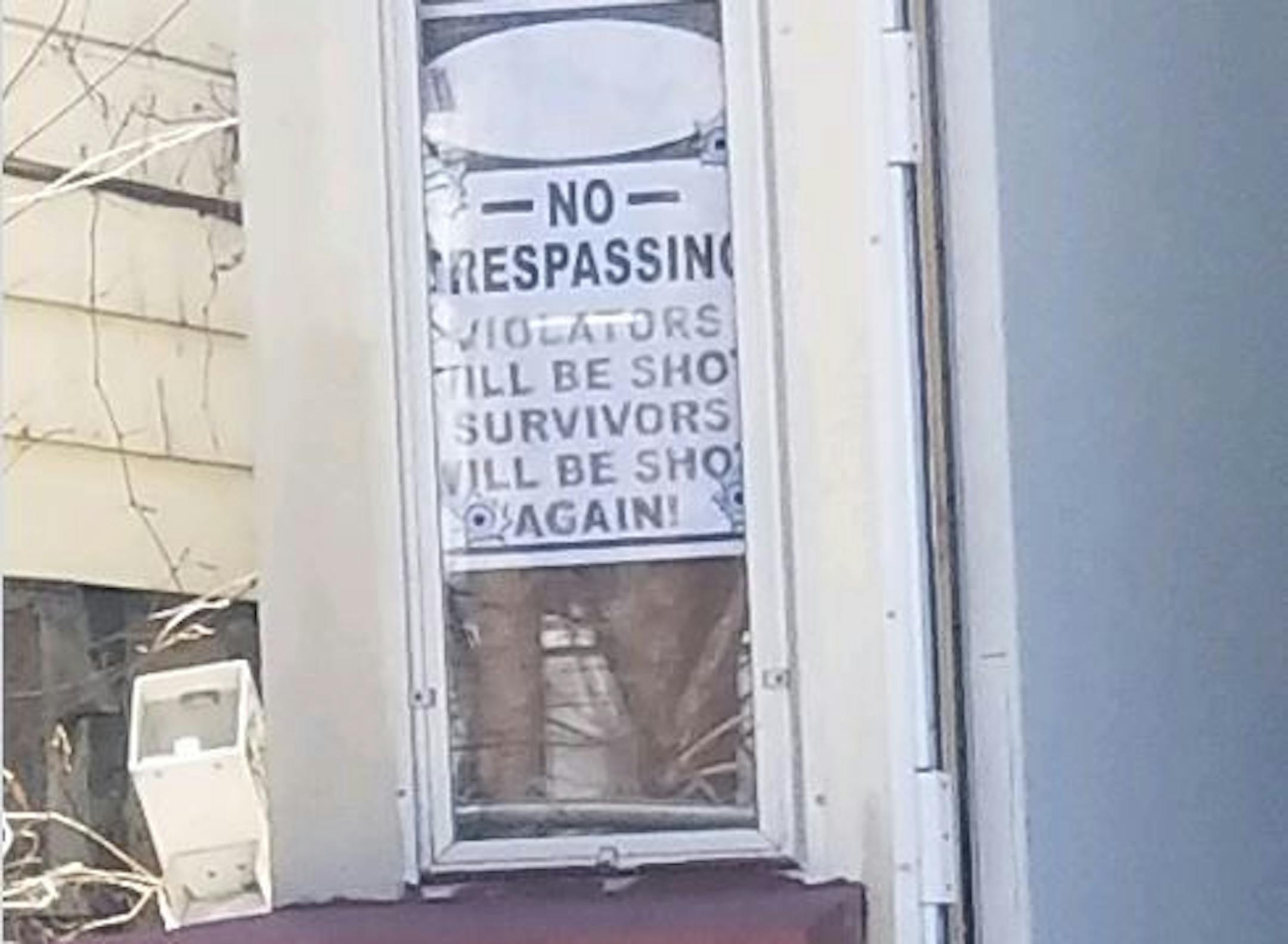 This sign was on the house of a homeowner who shot a man fleeing police Tuesday.