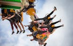 Fairgoers enjoy the Rock It ride on the Mighty Midway at the Minnesota State Fair on Friday, August 28, 2015.