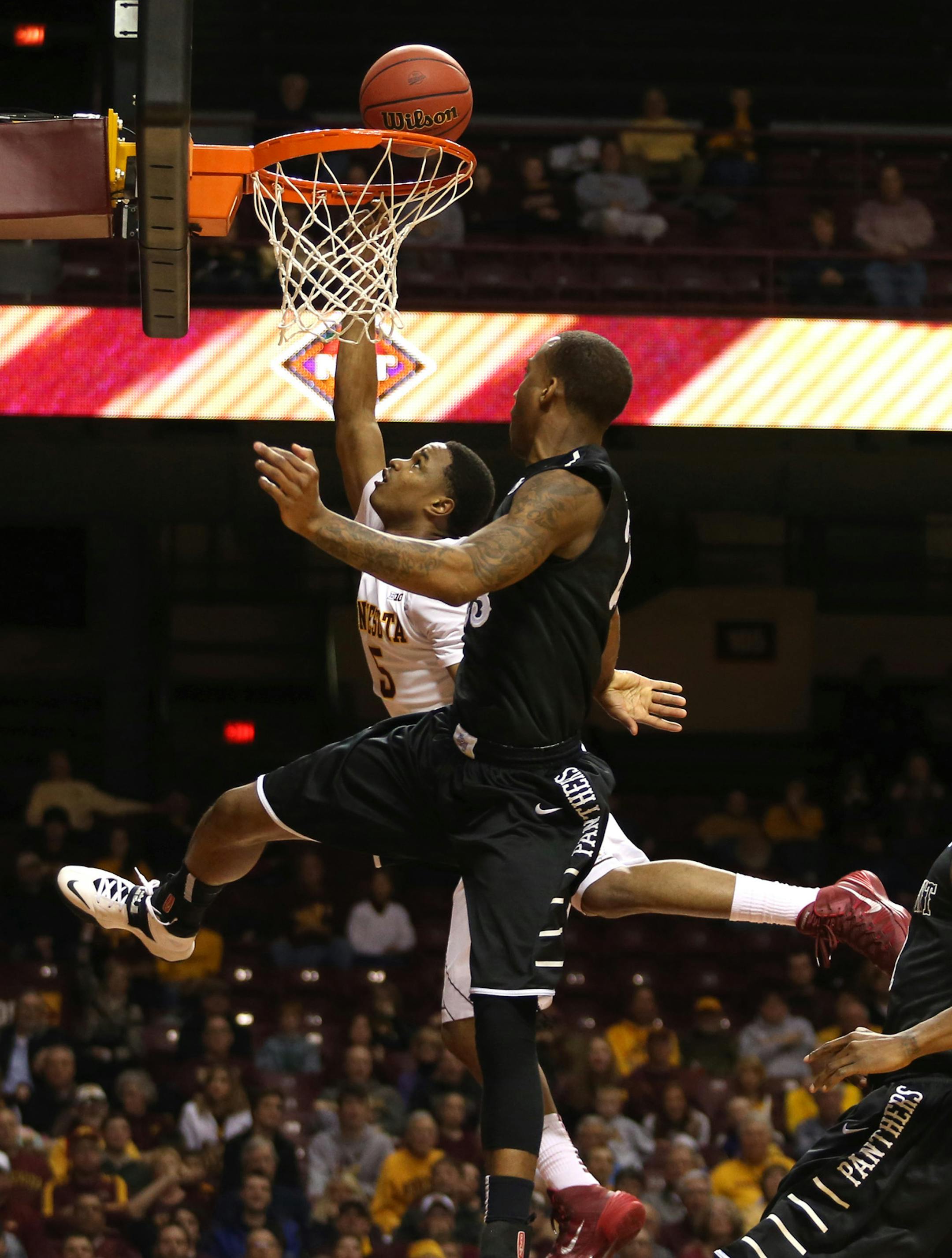 Gopher Daquein McNei made a layup against the High Point defense in the second half. ] (KYNDELL HARKNESS/STAR TRIBUNE) kyndell.harkness@startribune.com First round of the National Invitational Tournament at Williams Arena in Minneapolis Min, Tuesday March 18, 2014. Gophers won 88-81 over High Point.