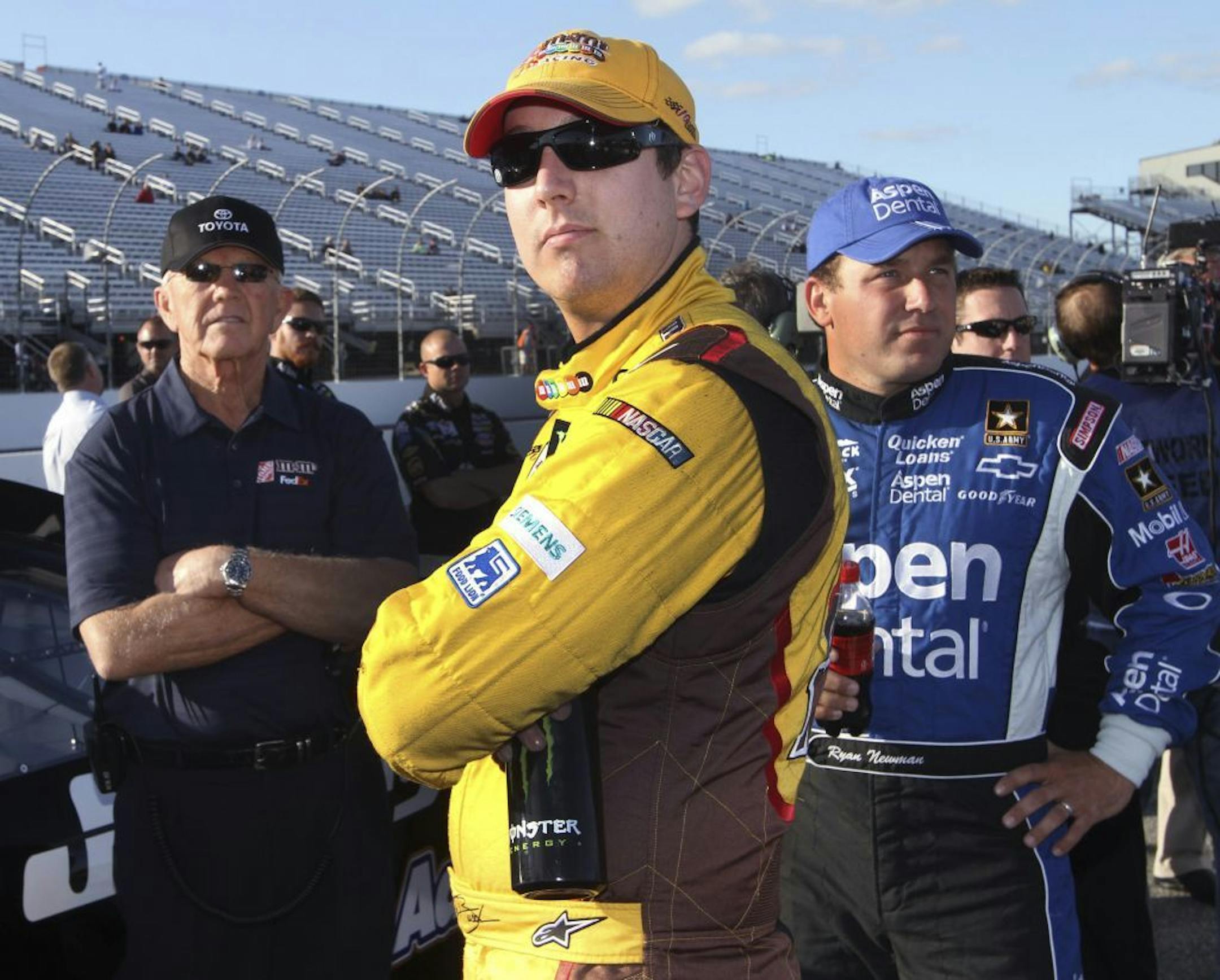 FILE - In this Sept. 21, 2012 file photo, NASCAR team owner Joe Gibbs, left, watches results with Kyle Busch, center, and Ryan Newman at New Hampshire Motor Speedway. Busch and Newman are the latest drivers to feud following a dust-up at New Hampshire.