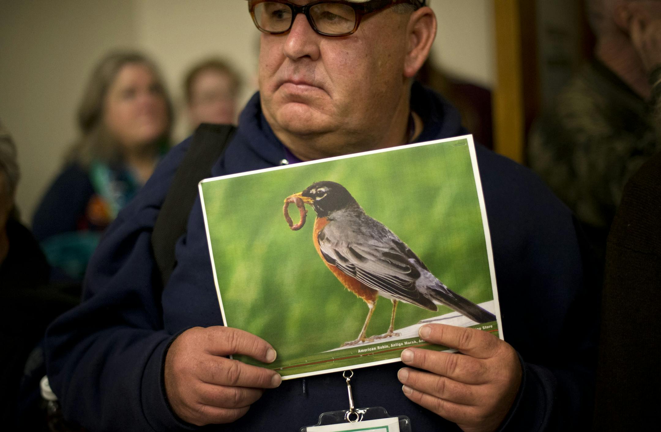 Michael Gorman brought a photo of a robin to the press conference representing nature he fears will be hurt by sand mining. Southeast Minnesota citizens spoke about the need for state regulation of sand mining, Tuesday, February 19, 2013 at a press conference. ] GLEN STUBBE * gstubbe@startribune.com