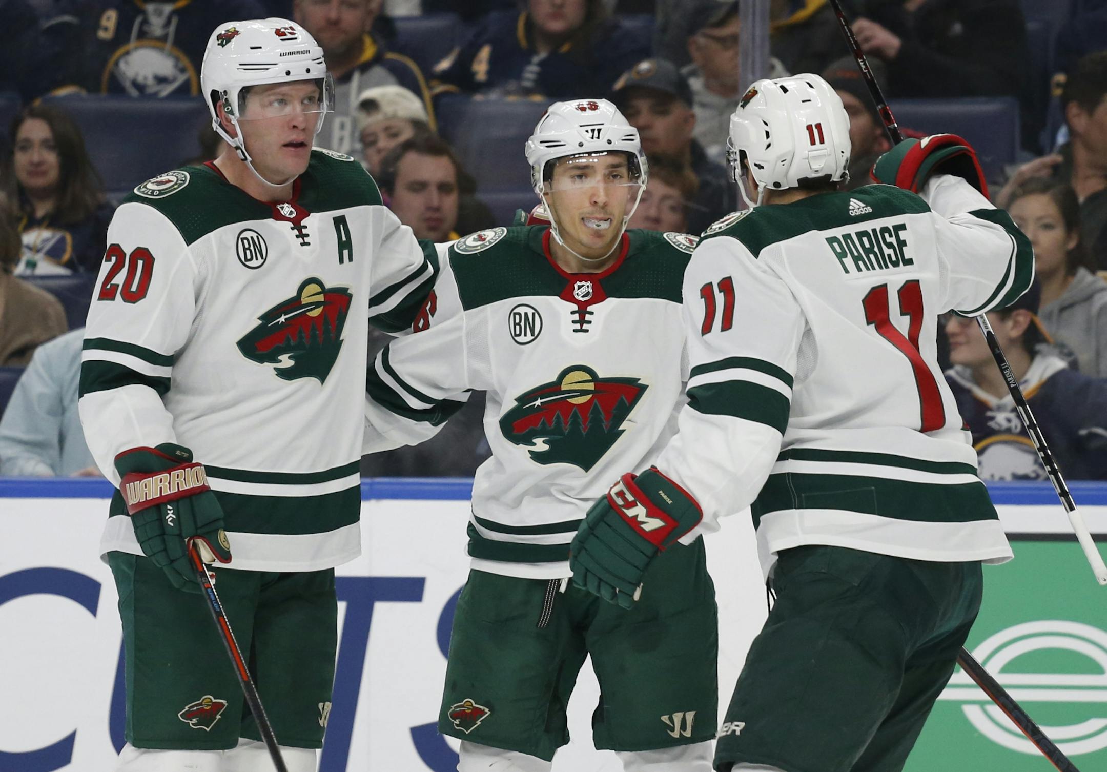 Minnesota Wild forward Jared Spurgeon, center, celebrates his second goal with teammates Ryan Suter, left, and Zach Parise, right, during the second period of an NHL hockey game against the Buffalo Sabres, Tuesday, Feb. 5, 2019, in Buffalo N.Y.