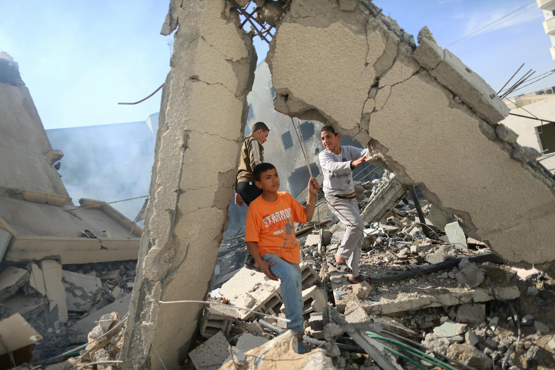 Palestinians climb among the rubble of the Hamas Ministry of Interior building, in Gaza City, Nov. 16, 2012. The Palestinian militant group Hamas claimed responsibility for rockets that were fired at Jerusalem, a city holy to Jews, Mulims and Christians, Friday. (Wissam Nassar/The New York Times)
