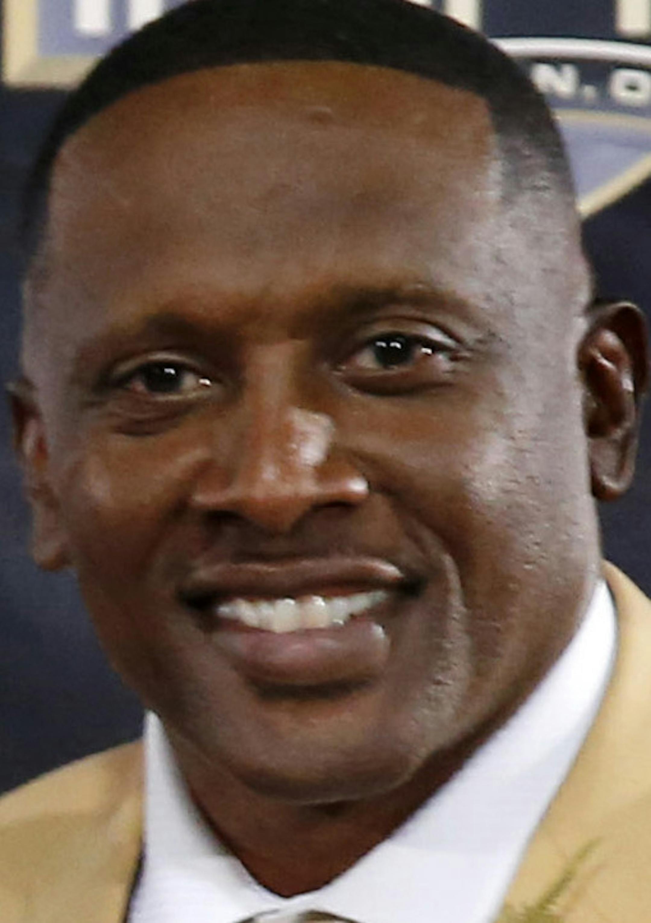 Former NFL player Tim Brown poses with his bust during inductions at the Pro Football Hall of Fame on Saturday, Aug. 8, 2015, in Canton, Ohio. (AP Photo/Gene J. Puskar)