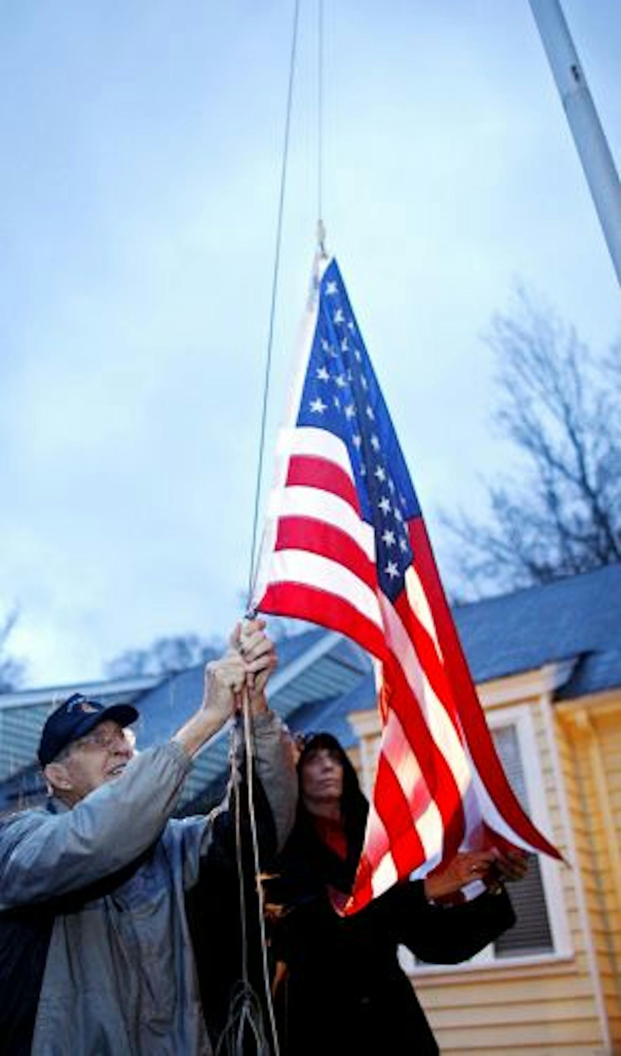 Col. Van T. Barfoot, 90 and a Medal of Honor recipient, and his daughter Margaret Nicholls lower the flag outside Barfoot's home in the Sussex Square subdivision in western Henrico County, Va., on Wednesday, Dec. 2, 2009. According to the subdivision's homeowner association's board, Col. Barfoot is in violation because he flies the flag from a flagpole instead of a pole attached to his porch or doorway. Col. Barfoot has been ordered to remove the pole by 5pm on Friday or face legal action.