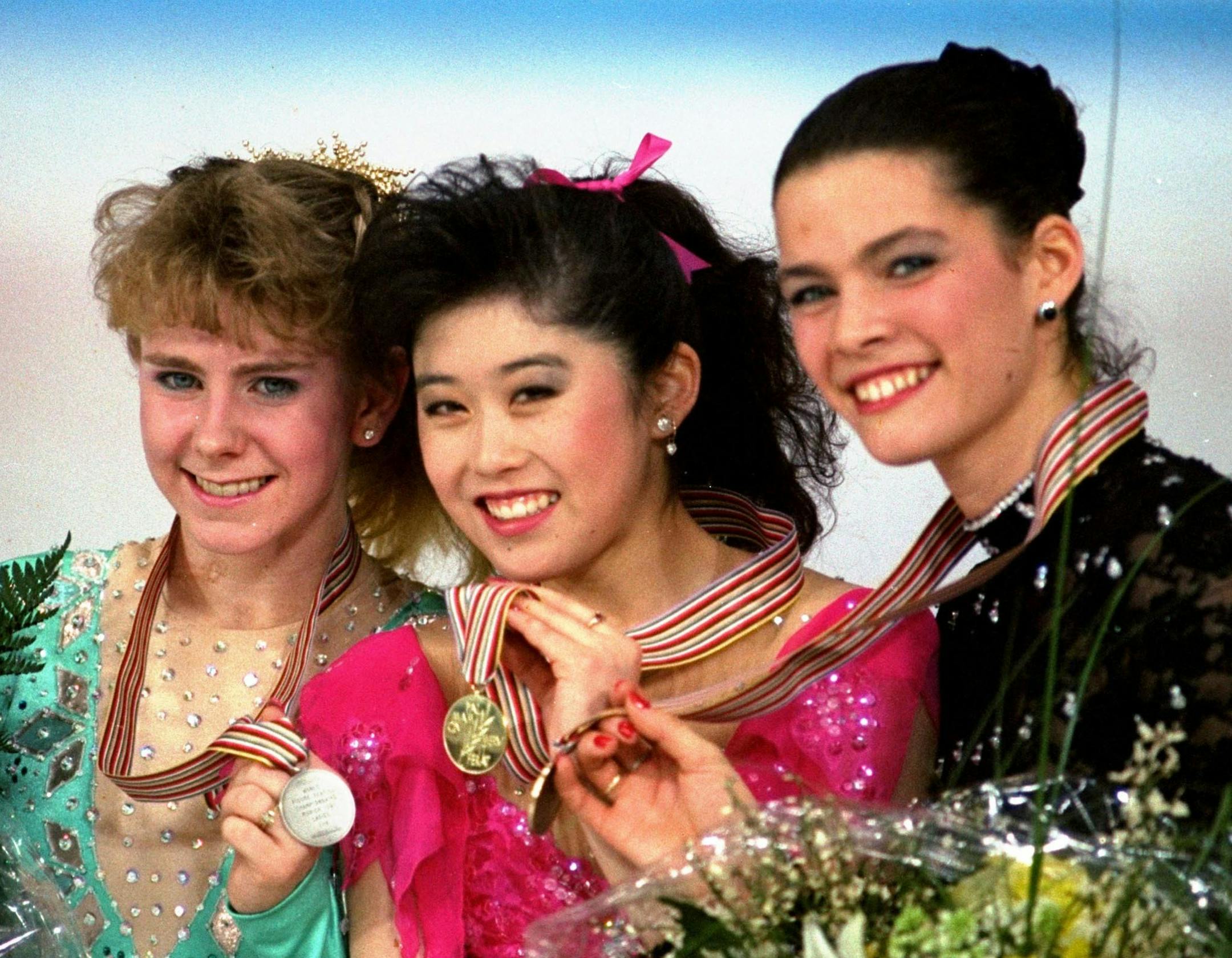 FILE - In this March 12, 1991, file photo, American skaters (L to R) Tonya Harding, silver; Kristi Yamaguchi, gold; and Nancy Kerrigan, bronze, display their medals after the finals of the World Figure Skating Championships in Munich. A run-of-the-mill good luck tweet from Yamaguchi to Kerrigan is drawing online attention. Yamaguchi tweeted a message to Kerrigan ahead of Kerrigan’s performance on Monday’s “Dancing with the Stars” March 20, 2017, and added “brea