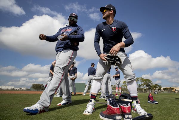 Miguel Sano and Josh Donaldson. take a break during a spring training workout in Fort Myers.