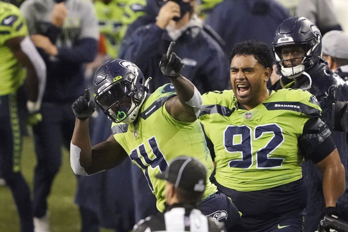 Seattle Seahawks' Bryan Mone (92) cheers on DK Metcalf (14) after Metcalf pulled in a long pass near the end of the second half of an NFL football game against the Minnesota Vikings, Sunday, Oct. 11, 2020, in Seattle. The Seahawks won 27-26.