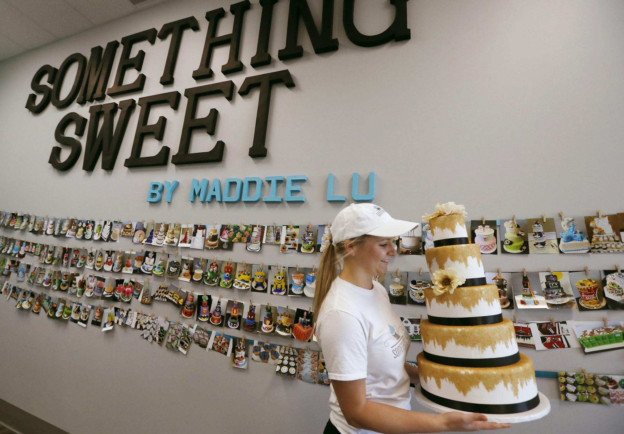 Maddie Carlos carried a display cake at Something Sweet by Maddie Lu Wednesday October 16, 2016 in Coon Rapids, MN. ] Jerry Holt / jerry. Holt@Startribune.com