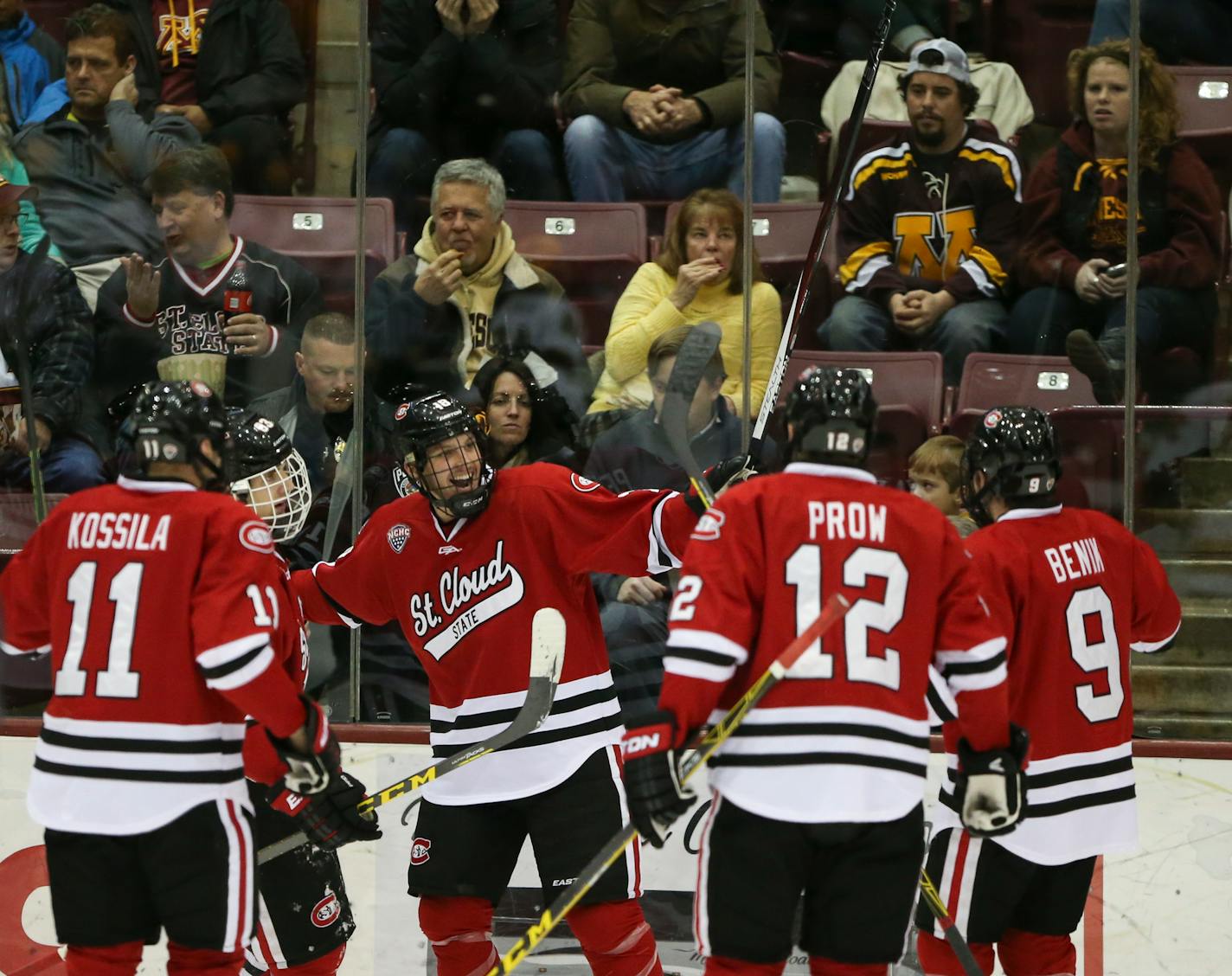 Huskies junior forward Judd Peterson (center, pictured in a November 2015 game against the Gophers) scored his third goal of the game with 1:13 remaining in regulation to erase a three-goal third-period deficit before teammate Jake Wahlin scored the game-winner on the power play with 2:07 remaining in overtime for a 6-5 overtime victory over the Gophers on Friday.