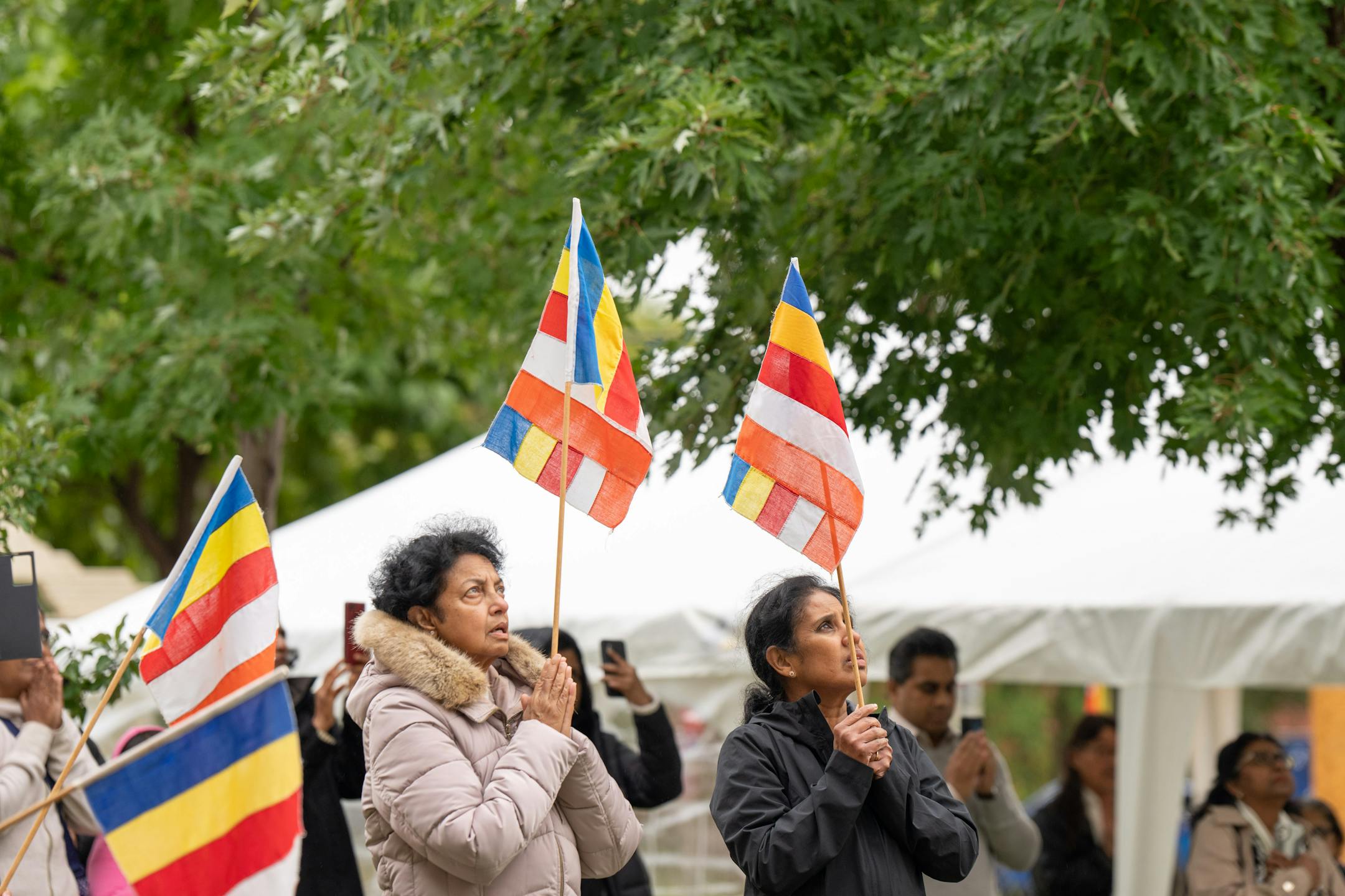 Participants held Buddhist flags during the ceremony Friday, Oct. 6, 2023 Minneapolis, Minn. This Stupa Unveiling marks a significant milestone in the history of Minnesota Buddhist Vihara and is an occasion of great joy and appreciation. A Stupa is a large white cement dome topped with a brass pinnacle. A sacred stupa is a physical structure in which a relic of the Buddha, enlightened beings, or holy books is enshrined. It creates an opportunity for people to circumambulate and cultivate positive vibration and spiritual development. ] GLEN STUBBE • glen.stubbe@startribune.com