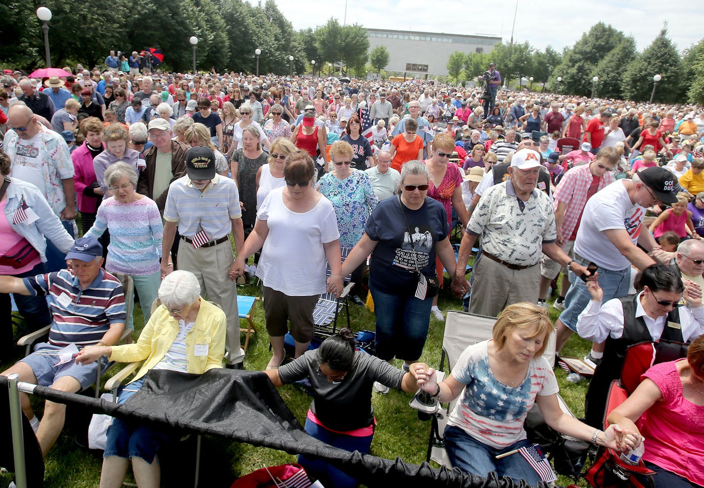 The Rev. Franklin Graham hosted a day of prayer, encouraging the throng of Christians gathered to get out and vote and become involved in politics on the local level Thursday, June 16, 2016, in the lower mall outside the State Capitol in St. Paul, MN. Here, those gathered joined hands in prayer.](DAVID JOLES/STARTRIBUNE)djoles@startribune The Rev. Franklin Graham hosted a day of prayer at the Minnesota Capitol. These gatherings are going on in all 50 states, and Minnesota's is next Thursday.