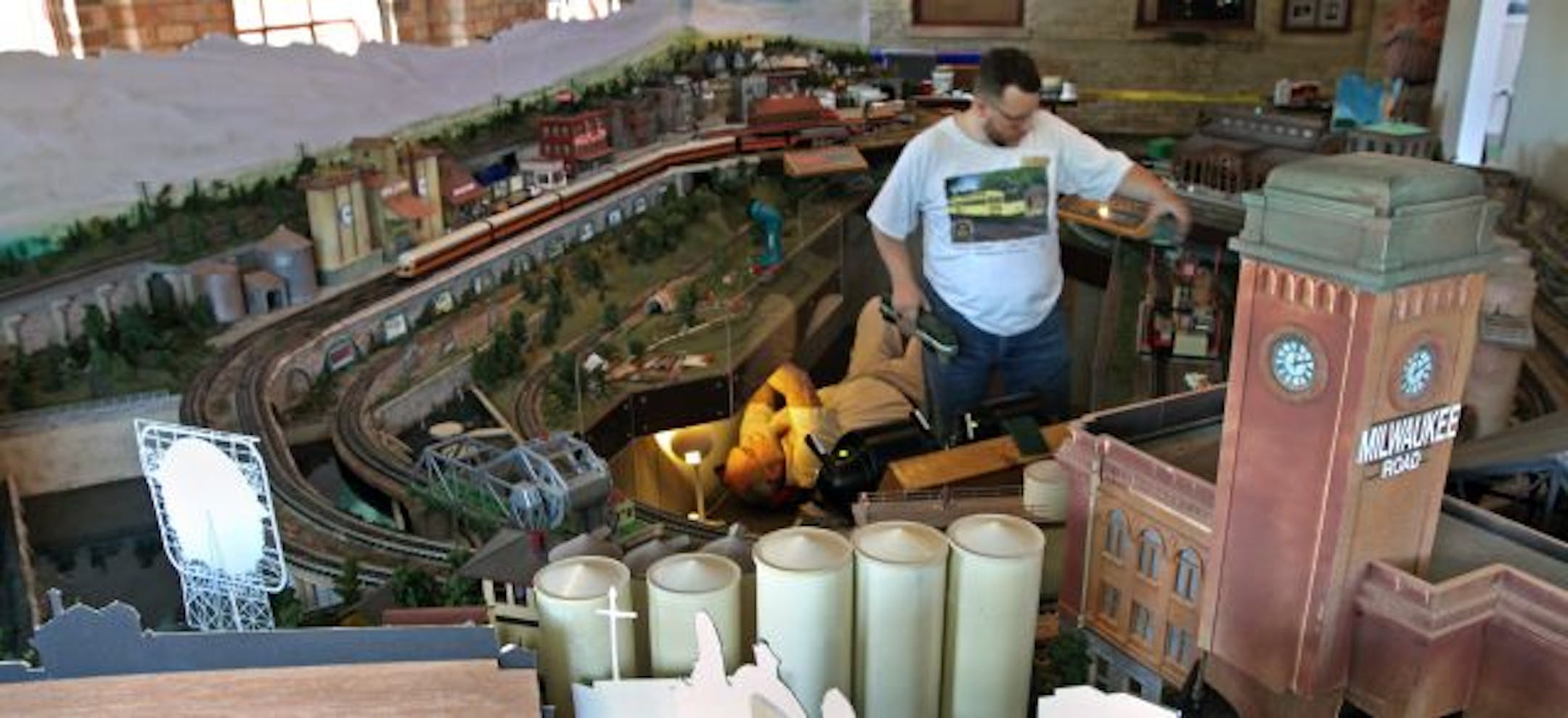 Peter Southard (beneath tracks) and Michael Helde worked on the layout, whose rail lines run atop the Stone Arch Bridge and past the depot, sundry mills, the Grain Belt billboard and other local landmarks.