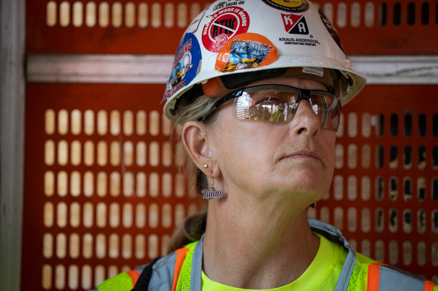 Operating engineer Connie Smallman wears her Twins earrings on game days while working the elevator of the North Loop Green construction project on Thursday, June 22, 2023 in Minneapolis, Minn. ] LEILA NAVIDI • leila.navidi@startribune.com