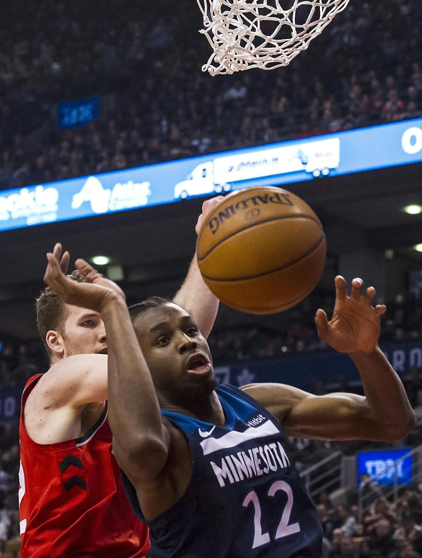 Minnesota Timberwolves forward Andrew Wiggins (22) and Toronto Raptors center Jakob Poeltl (42) fight for a rebound during the first half of an NBA basketball game against the Minnesota Timberwolves, Tuesday, Jan. 30, 2018 in Toronto. (Christopher Katsarov/The Canadian Press via AP)