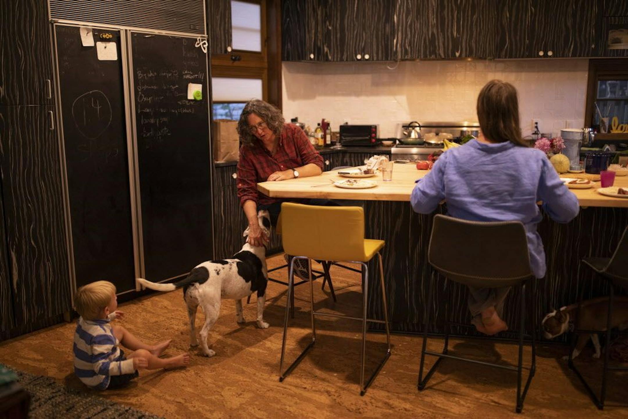 Kim Bartmann sat at the kitchen island with her wife, Sarah Jane Wroblewski, while telling her son, Emmitt, that he'd better eat a little more of his dinner if he wants to be in the dessert club.