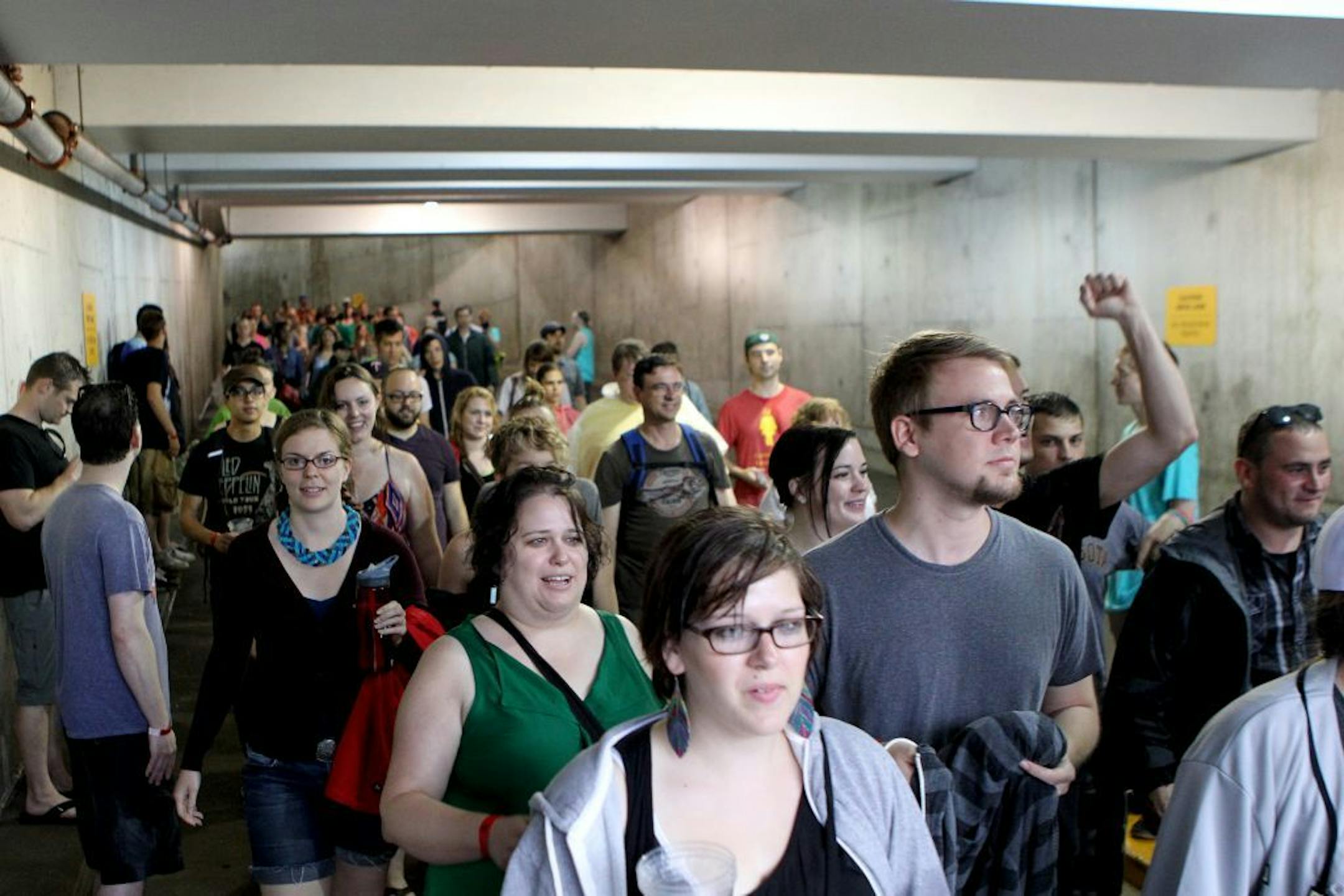 People move out of the parking garage after the rain at the Rock the Garden concert at the Walker Art Center/Minneapolis Sculpture Garden on Saturday, June 15, 2013. The first act, Dan Deacon, was moved inside a parking garage because of rain.The event featured Dan Deacon, Low, Bob Mould Band, Silversun Pickups and headliner Metric.