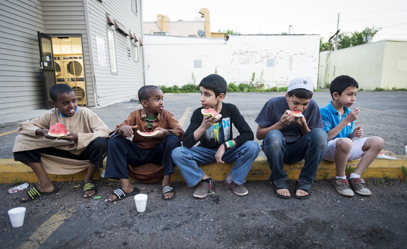 From left, Ayub, 11, Suheb, 10, Ali, 11, Mustafa, 12, and Amro, 9, gathered for Iftar, the breaking of their fast, on the first day of Ramadan with watermelon, milk and dates outside the Islamic Cultural Community Center in Minneapolis Thursday night. ] Aaron Lavinsky &#x2022; aaron.lavinsky@startribune.com The start of the month-long Muslim holiday of Ramadan was celebrated at Al Huda, the Islamic Cultural Community Center, Thursday night in Minneapolis. The Muslim holy month, marked by daily f