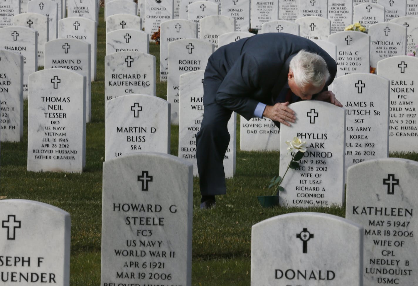 Richard Coonrod kissed the headstone marking the burial site of his wife, Phyllis Coonrod, at Fort Snelling National Cemetery. She died Dec. 28, 2012. They had been married 53 years.