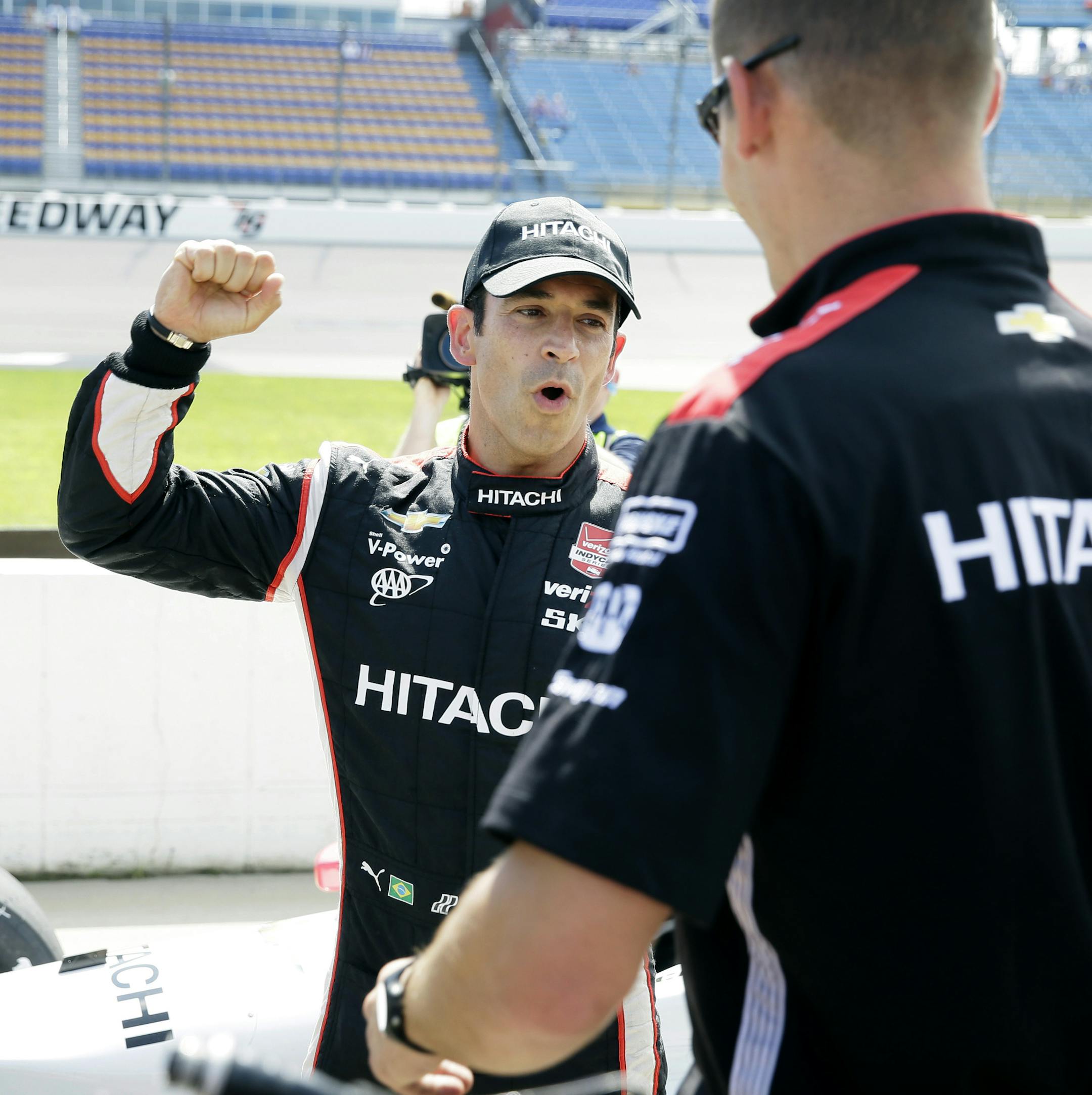 Helio Castroneves reacts after winning the pole position in the IndyCar Series auto race Saturday, July 18, 2015, at Iowa Speedway in Newton, Iowa. (AP Photo/Charlie Neibergall)