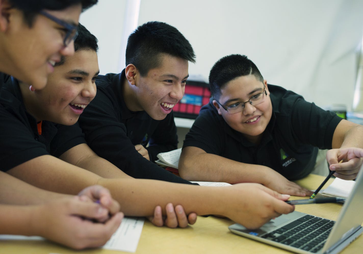 In Andres Gonzalez's science class, 8th graders , left to right, Joel Perez, Edgar Chaveras, Brian Zhagui, and Ernesto Garibay checked out tectonic fault lines across the world. Hiawatha Academies is fighting some history as it seeks approval for a plan to temporarily school its high school students at the old Northrop school for three years.Richard Tsong-Taatarii/ rtsong- taatarii@startribune.com