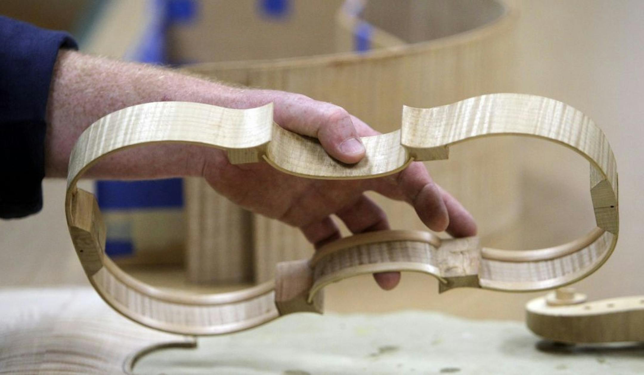 Jonno Woutat, an instructor at North Country Woodshop, showed off his violin frame to the a fellow instructor at North Country Woodshop Tuesday, July 5, 2011. Woutat also owns his own business called Woutat Violins where he makes, restores and repairs violins.