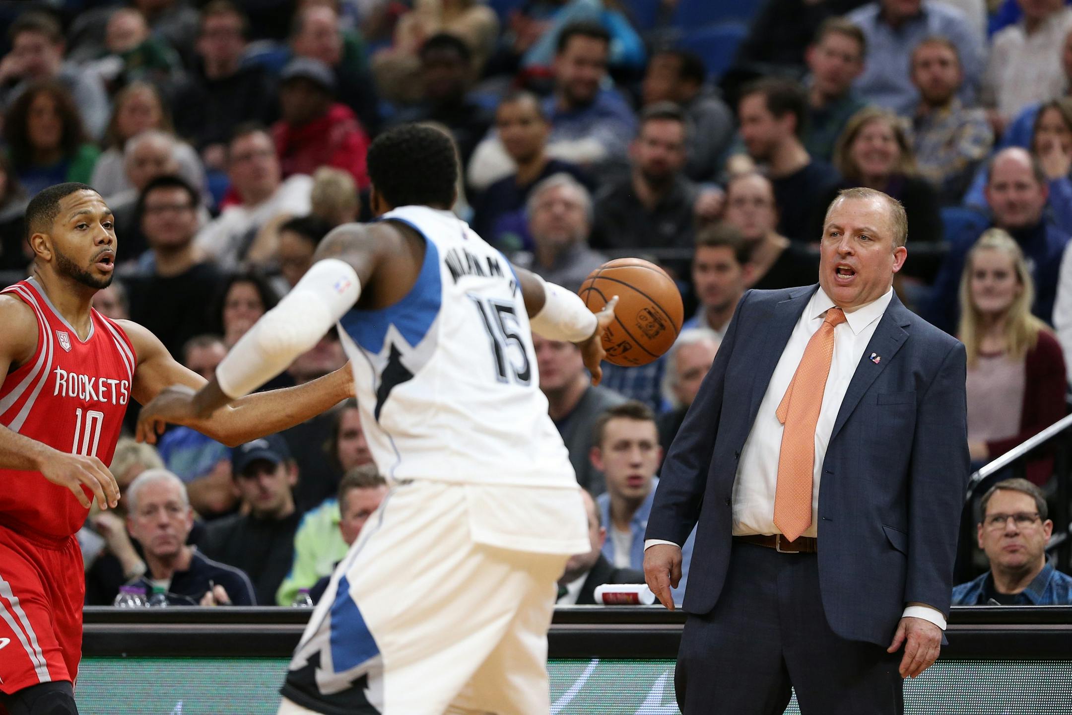 Minnesota Timberwolves head coach Tom Thibodeau watches from the sidelines as Minnesota Timberwolves forward Shabazz Muhammad (15) tries to defend against Houston Rockets guard Eric Gordon (10) in the second half.