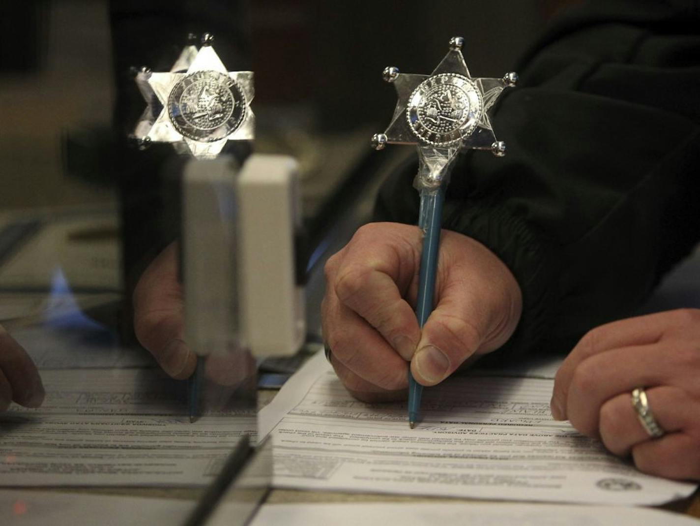 A man who would give only his first name of Charles filled out the paperwork for a handgun permit to carry Tuesday, Dec. 18, 2012, at the Anoka County Sheriff's Office in Andover, MN. He believes the most recent shooting in Connecticut may be influencing people to get permits to purchase. The shooting did not, however, influence his decision to get a purchase to carry permit, he said. "Nothing in the news lately made me want to get a purchase to carry," he said, adding that even with a permit he