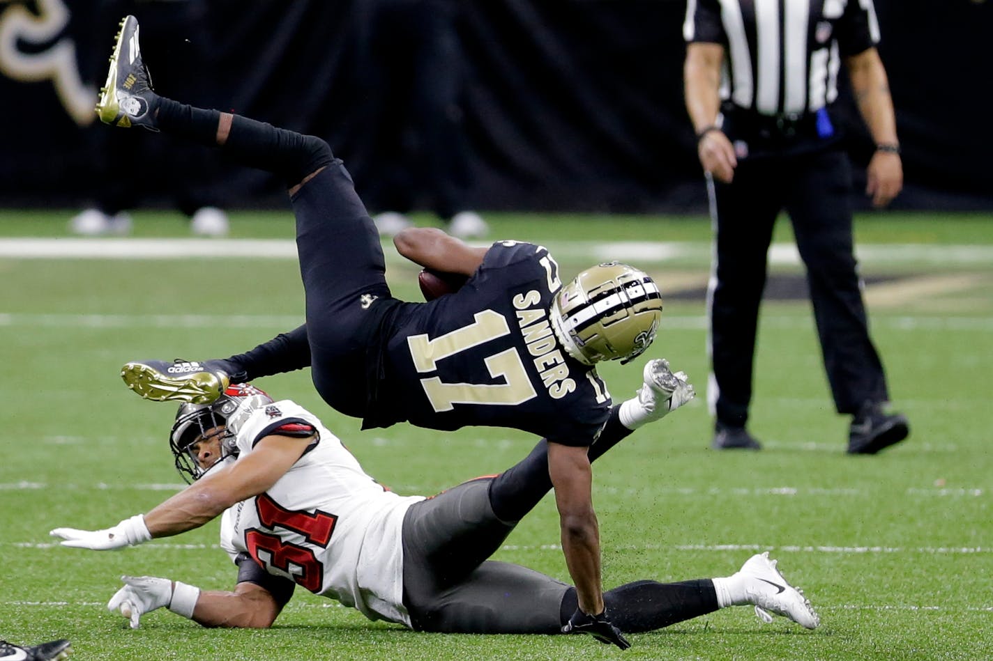 New Orleans Saints wide receiver Emmanuel Sanders (17) makes the catch as Tampa Bay Buccaneers strong safety Antoine Winfield Jr. (31) defends during the second half of an NFL divisional round playoff football game, Sunday, Jan. 17, 2021, in New Orleans. (AP Photo/Brett Duke)