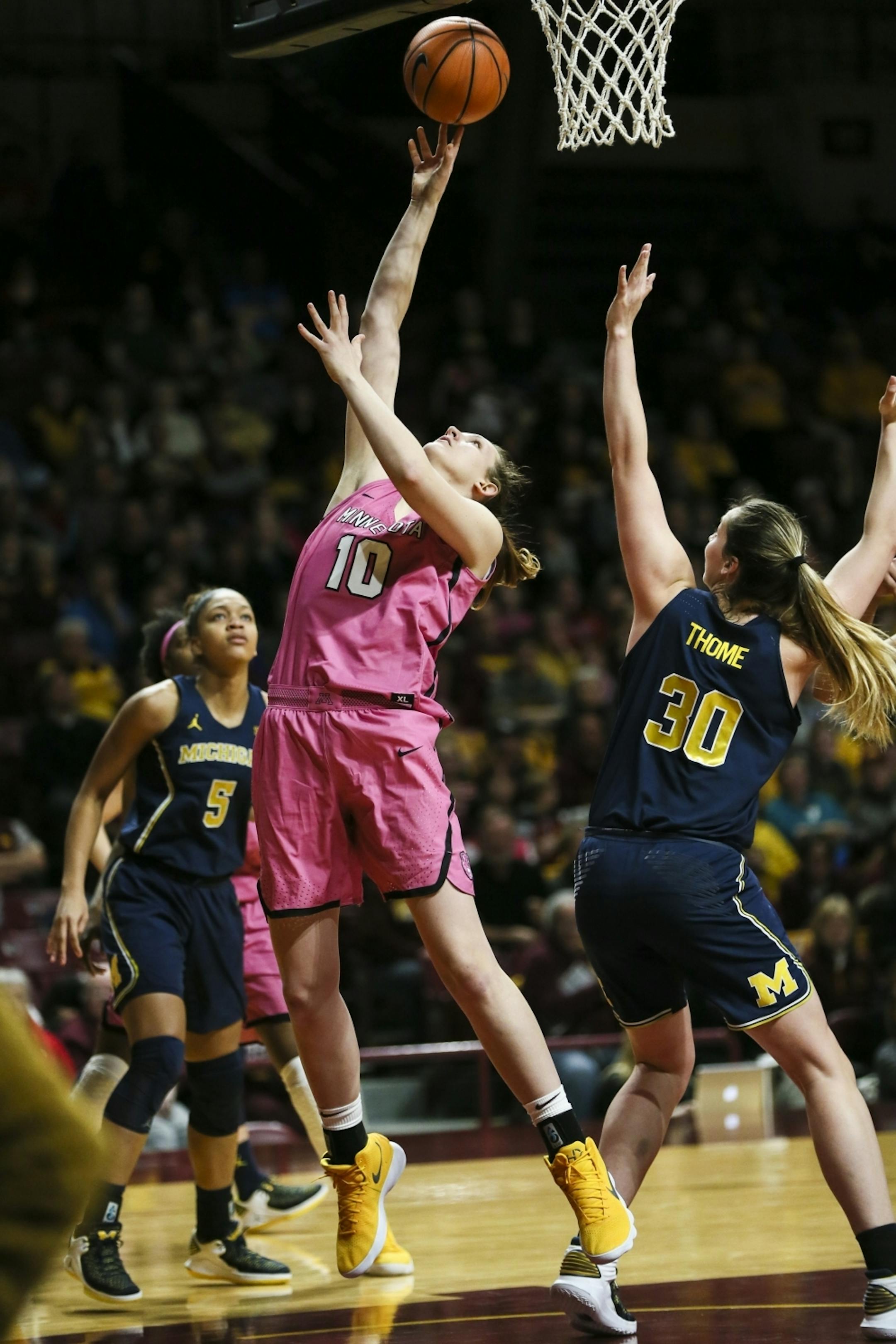 Minnesota Golden Gophers center Jessie Edwards (10) went for a shot against Michigan Wolverines Hallie Thome (30) in the first half.